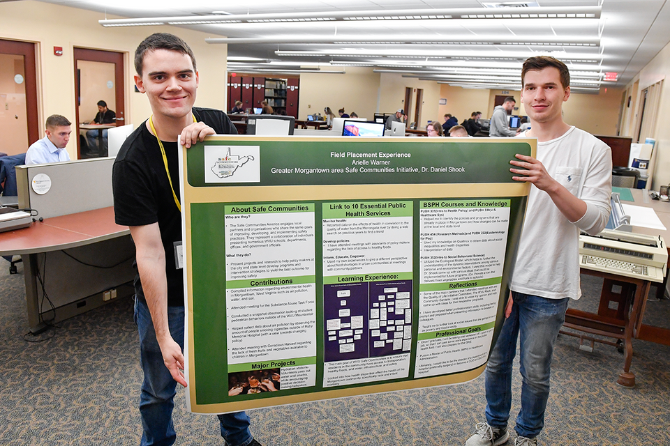 students holding poster