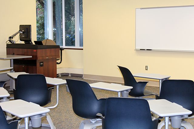 moveable chairs, instructor podium, and whiteboard.